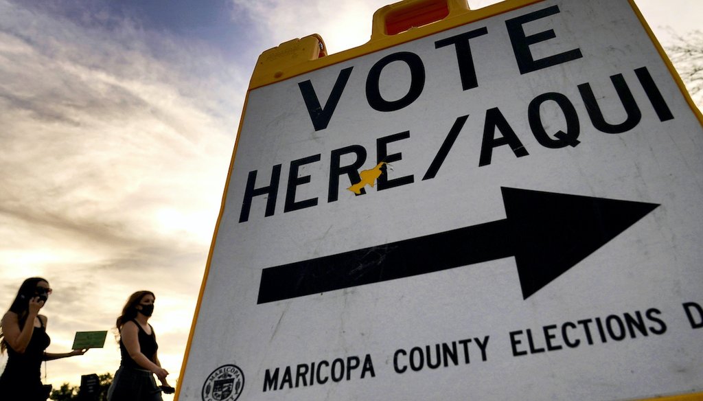 Voters deliver their ballots to a polling station in Tempe, Ariz., Nov. 3, 2020.