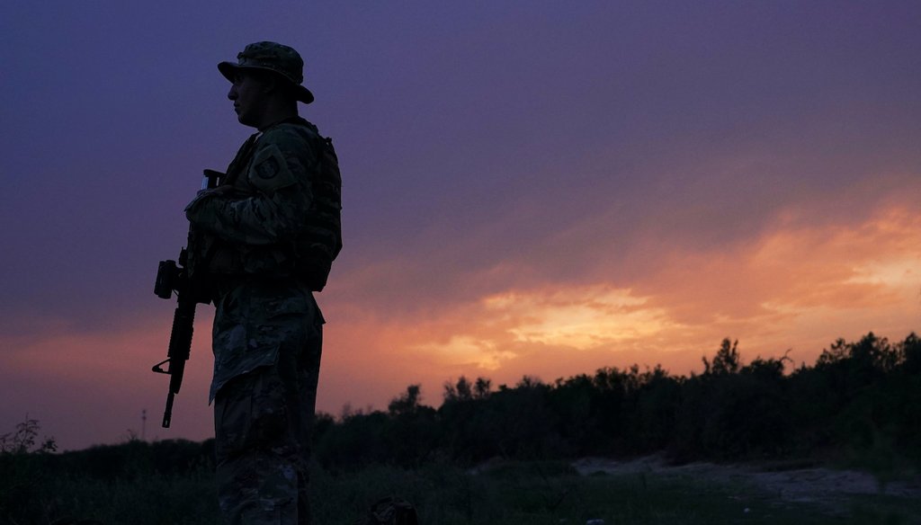 A member of the Texas Military Department stands guard along the U.S.-Mexico border Tuesday, May 11, 2021, in Roma, Texas.