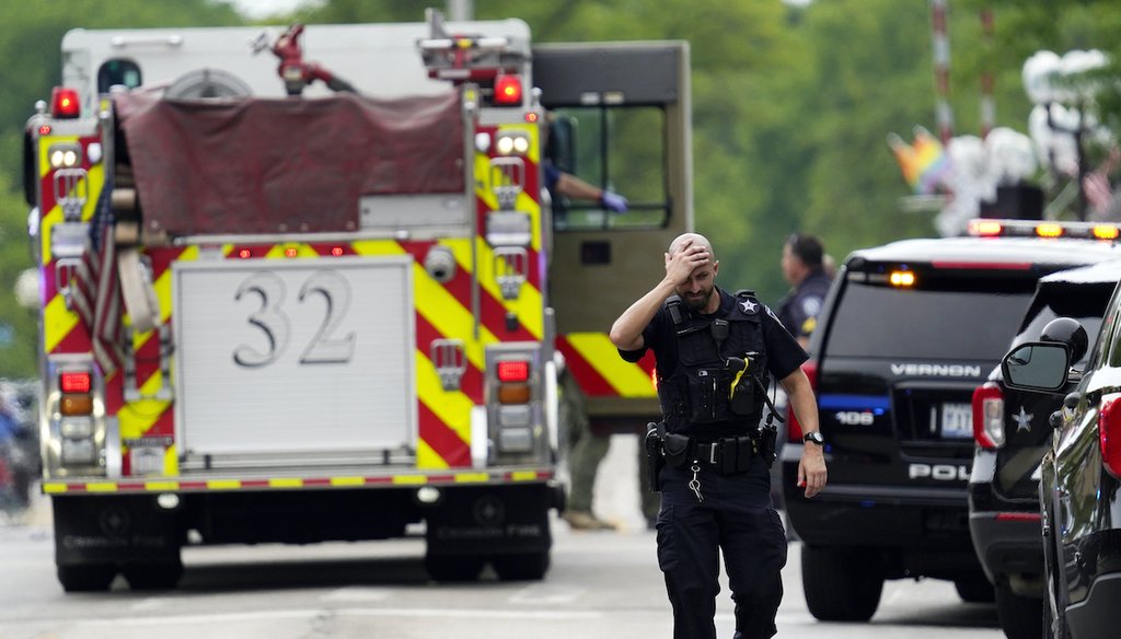 A police officer reacts as he walks in downtown Highland Park, Ill., a suburb of Chicago, July 4, 2022, where a mass shooting took place at a Fourth of July parade. (AP)