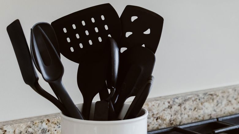 Close-up view of cooking utensils in container on kitchen counter